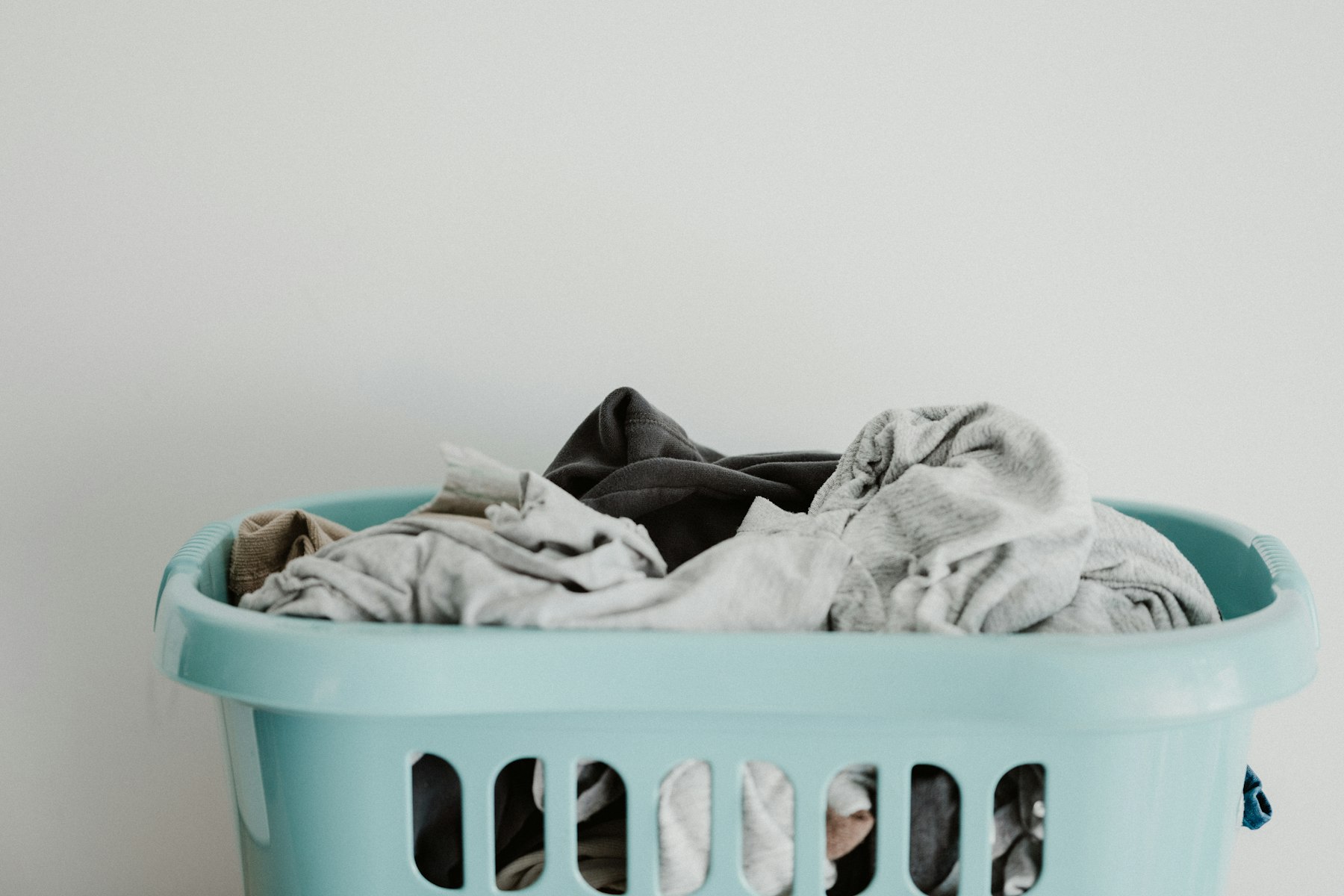 Laundry pickup bags arranged and ready at a clean entryway.